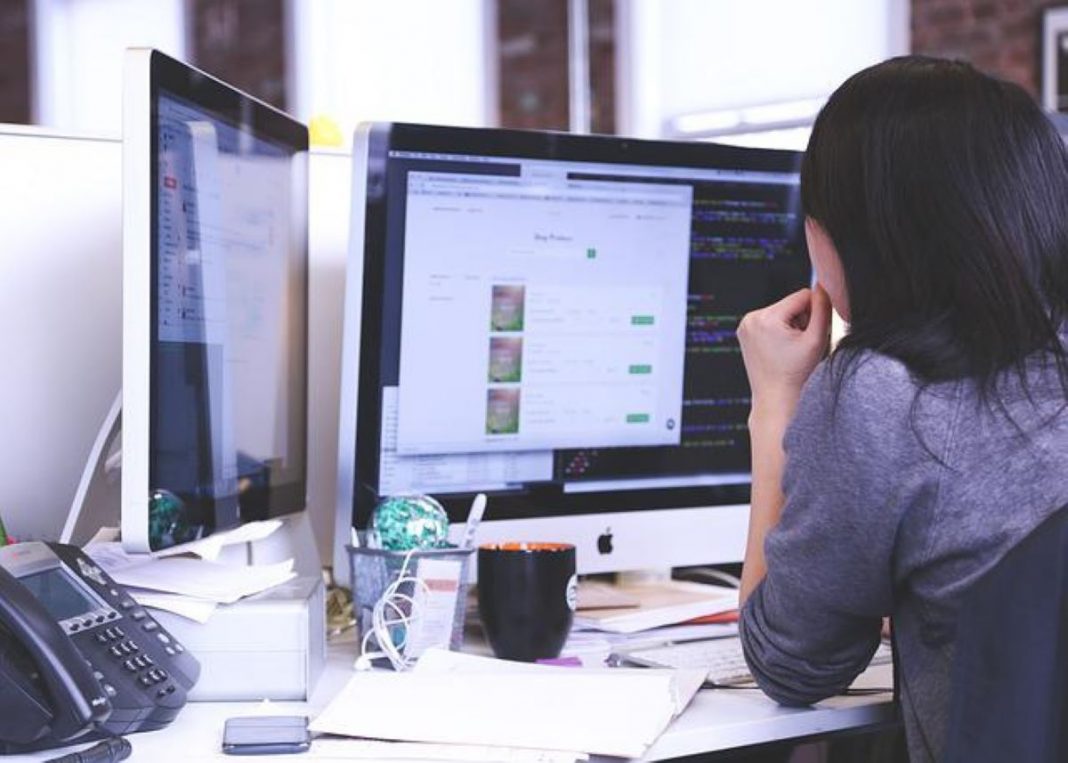 A person looking at the computer screen