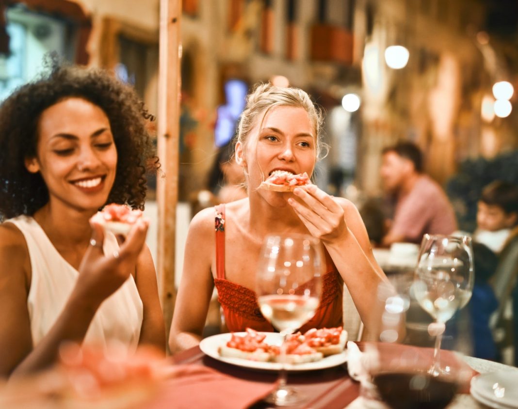 Friends enjoying dinner at a restaurant.