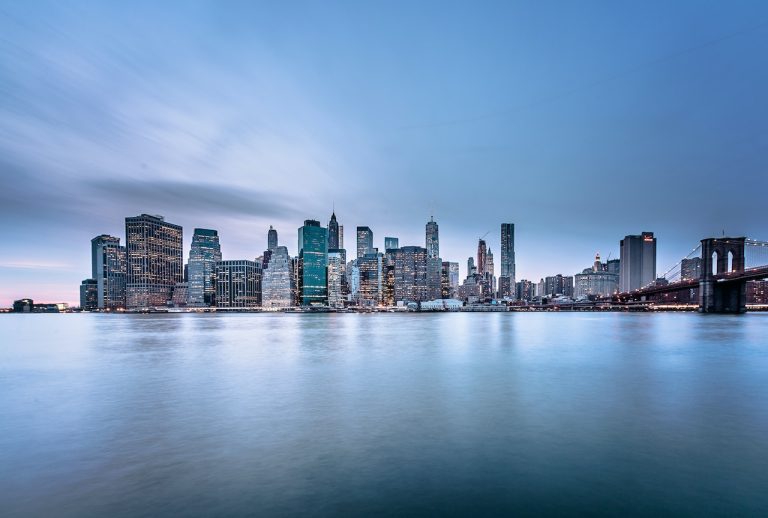 A body of water near some city buildings.